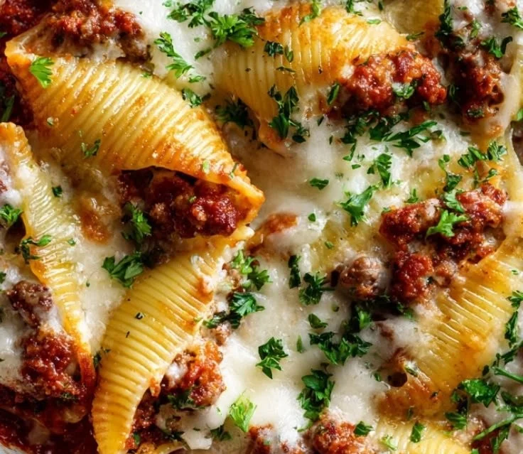 Cheesy sausage stuffed jumbo shells on a plate, ready to serve.
