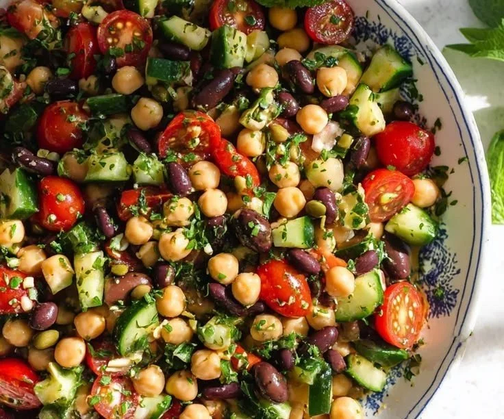 Mediterranean chickpea bowl filled with fresh vegetables and herbs