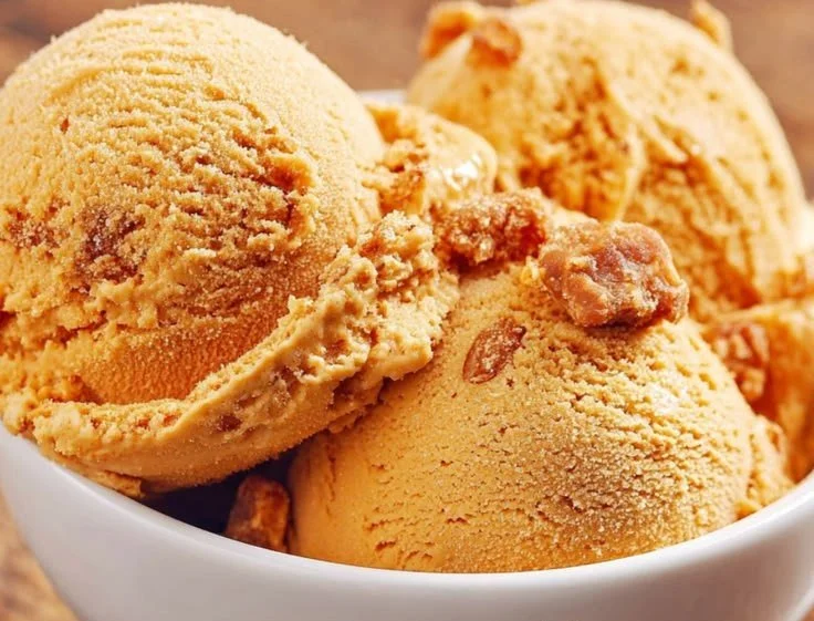 Delicious Pumpkin Ice Cream served in a bowl with autumn decorations.